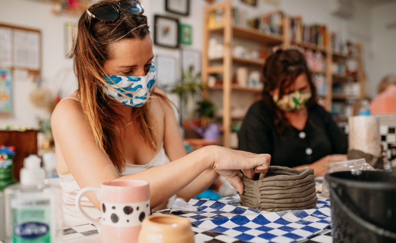 Women wearing facemasks making pottery in a Yuup workshop